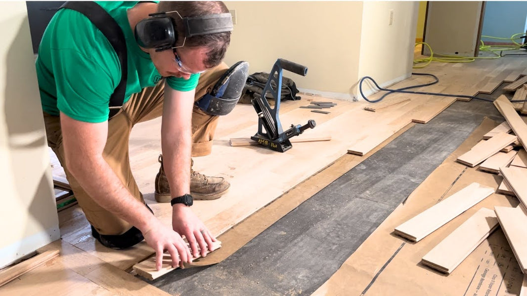 hardwood floor installer using a nailer
