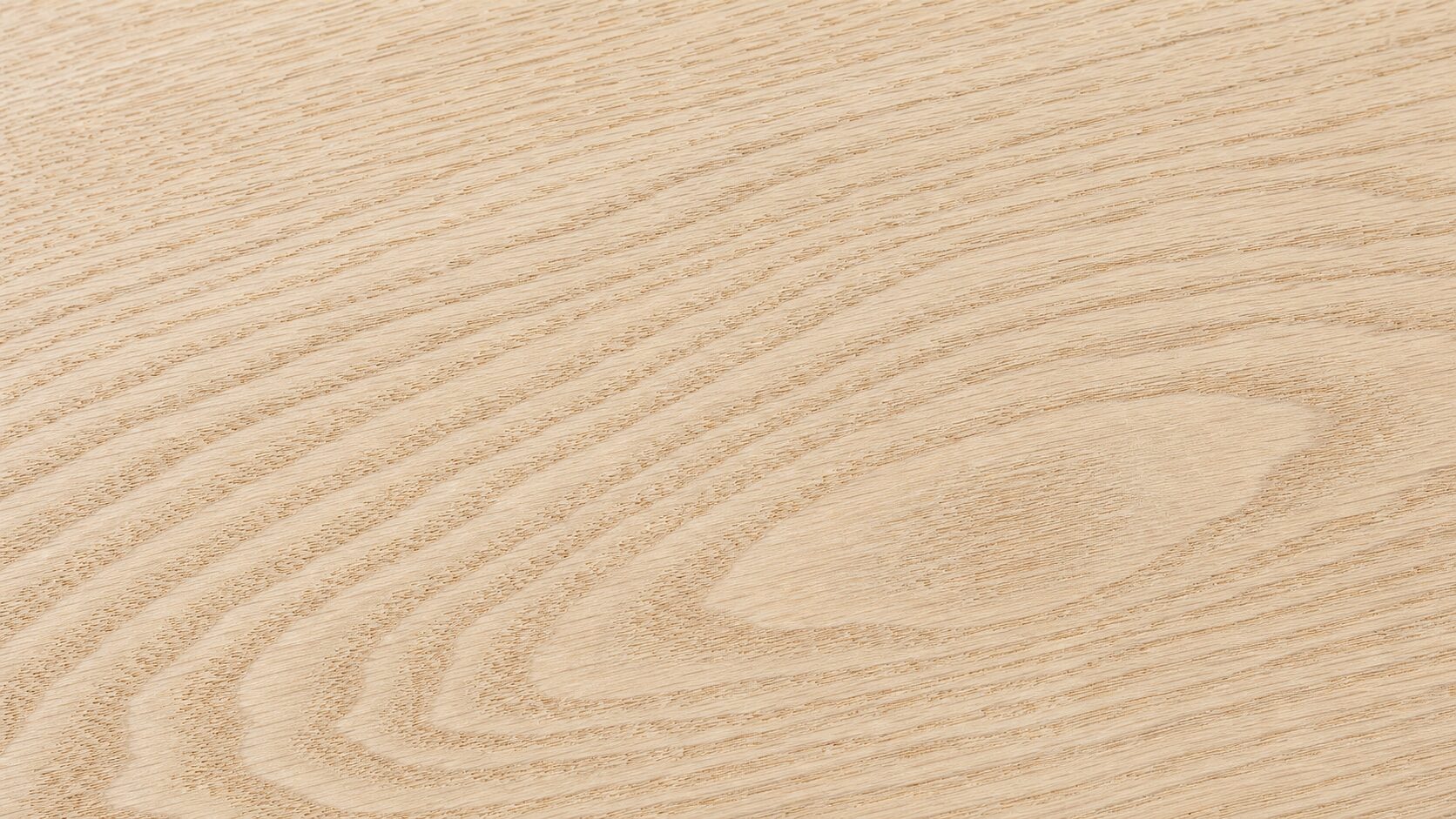 Close-up of unfinished Easiklip solid white oak hardwood showing natural grain and pale honey-tan color